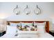 A serene bedroom featuring a wooden headboard and decorative candle sconces above the pillows at 7461 Michelle Rd, Rocky Mount, NC 27803