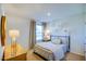 Comfortable bedroom featuring a large window, soft lighting, and cozy bedding at 7461 Michelle Rd, Rocky Mount, NC 27803