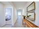 Bright hallway with wooden floors and decor leading to bedroom and living spaces at 7461 Michelle Rd, Rocky Mount, NC 27803