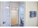Hallway with a view of a nearby bathroom and access to a bedroom with wire shelving at 7461 Michelle Rd, Rocky Mount, NC 27803