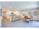 Open kitchen features white cabinets, stainless appliances, a center island, and adjacent dining area at 7461 Michelle Rd, Rocky Mount, NC 27803