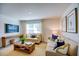 Comfortable living room showcasing sofas, a wooden coffee table, and wall-mounted television at 7461 Michelle Rd, Rocky Mount, NC 27803