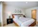 Bedroom with hardwood frame bed and nightstands, and a bathroom entrance at 7461 Michelle Rd, Rocky Mount, NC 27803