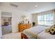 Stylish bedroom with a wood dresser, mirror, decor, and light from a window at 7461 Michelle Rd, Rocky Mount, NC 27803