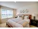 Cozy bedroom with natural light, decorative lamps, and a well-dressed bed at 7461 Michelle Rd, Rocky Mount, NC 27803