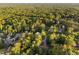 Aerial view of a neighborhood with lush trees and winding roads at 7808 Umstead Forest Dr, Raleigh, NC 27612