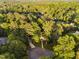 Aerial view of a tree-lined neighborhood with various home styles at 7808 Umstead Forest Dr, Raleigh, NC 27612