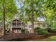 Lovely backyard with a two-story deck, beautiful yard and mature trees offering shade and privacy at 7808 Umstead Forest Dr, Raleigh, NC 27612