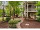 Inviting backyard features a stone fireplace, patio, and lush landscaping, perfect for outdoor relaxation and entertaining at 7808 Umstead Forest Dr, Raleigh, NC 27612