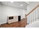 Finished basement features a wet bar with small refrigerator, hardwood floors, and white walls and trim at 7808 Umstead Forest Dr, Raleigh, NC 27612