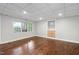 Hardwood floor basement with built-in shelves and cabinet, natural light from window, and recessed lighting at 7808 Umstead Forest Dr, Raleigh, NC 27612