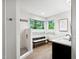 This bathroom provides a spacious, tiled shower, stone floors, and a bright window at 7808 Umstead Forest Dr, Raleigh, NC 27612