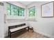 Bathroom boasts bright windows, providing natural light, and a small bench at 7808 Umstead Forest Dr, Raleigh, NC 27612
