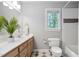 Bathroom boasts a single vanity, updated mirror, and natural light from the window at 7808 Umstead Forest Dr, Raleigh, NC 27612
