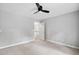 Bedroom with neutral walls and carpet features an open doorway with a view of the stairs and the rest of the home at 7808 Umstead Forest Dr, Raleigh, NC 27612