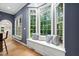 Breakfast nook with a bay window, a window seat with storage, and pillows for seating at 7808 Umstead Forest Dr, Raleigh, NC 27612