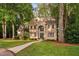 Charming two-story brick home with a manicured lawn and mature trees in a desirable neighborhood at 7808 Umstead Forest Dr, Raleigh, NC 27612