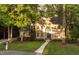 Charming brick home featuring a landscaped front yard and inviting entryway at 7808 Umstead Forest Dr, Raleigh, NC 27612