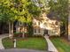 Charming brick home featuring a landscaped front yard and inviting entryway at 7808 Umstead Forest Dr, Raleigh, NC 27612