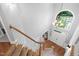 View of the two-story foyer, with stairs, chandelier and large arched window at 7808 Umstead Forest Dr, Raleigh, NC 27612