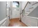 Inviting foyer with hardwood floors, staircase, and double front doors with a large window above at 7808 Umstead Forest Dr, Raleigh, NC 27612