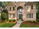 Elegant brick home featuring a grand entrance with a soaring arch and double doors at 7808 Umstead Forest Dr, Raleigh, NC 27612