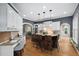 Open kitchen features granite countertops, stainless appliances, a center island with seating, and a built-in desk at 7808 Umstead Forest Dr, Raleigh, NC 27612