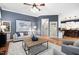 Inviting living room with hardwood floors, modern furniture, and a decorative ceiling fan at 7808 Umstead Forest Dr, Raleigh, NC 27612