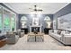 A spacious living room features a fireplace, recessed lighting, natural light, and neutral-toned furniture at 7808 Umstead Forest Dr, Raleigh, NC 27612