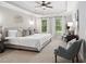 Relaxing primary bedroom with tray ceilings, neutral tones, and ample natural light at 7808 Umstead Forest Dr, Raleigh, NC 27612