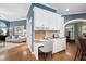 A built-in office area with granite countertops, white cabinets, drawers, and open access to the living room at 7808 Umstead Forest Dr, Raleigh, NC 27612