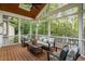 Screened-in porch boasts natural light, wood flooring, and plenty of room for entertaining at 7808 Umstead Forest Dr, Raleigh, NC 27612