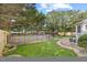 A lush green backyard with a dark metal fence at 8517 Evans Mill Pl, Raleigh, NC 27613