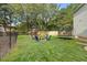 Spacious backyard features a fire pit, play set, trampoline, and fenced-in yard at 8517 Evans Mill Pl, Raleigh, NC 27613