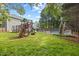 Large backyard features a playset and swimming pool area, surrounded by a secure fence at 8517 Evans Mill Pl, Raleigh, NC 27613