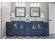 Double sink vanity with grey cabinets and gold hardware and fixtures at 8517 Evans Mill Pl, Raleigh, NC 27613