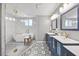 Modern bathroom featuring a luxurious soaking tub and double sink vanity at 8517 Evans Mill Pl, Raleigh, NC 27613