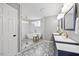 Bright bathroom featuring double vanity sinks, and a glass enclosed tub at 8517 Evans Mill Pl, Raleigh, NC 27613