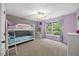 bedroom with bunk beds, large window and view of the yard at 8517 Evans Mill Pl, Raleigh, NC 27613