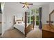 Cozy bedroom with vaulted ceilings, large windows, and a four-poster bed, offering a tranquil retreat at 8517 Evans Mill Pl, Raleigh, NC 27613