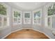 Breakfast nook features hardwood floors, white trim, and a three-window bay at 8517 Evans Mill Pl, Raleigh, NC 27613