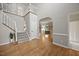 Inviting foyer with hardwood floors, staircase, and neutral paint creating a bright and open entrance at 8517 Evans Mill Pl, Raleigh, NC 27613