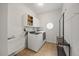 Laundry room with storage cabinets, sink, washer, and dryer at 8517 Evans Mill Pl, Raleigh, NC 27613