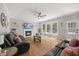 Bright living room boasts hardwood floors, ceiling fan, fireplace, and access to the backyard at 8517 Evans Mill Pl, Raleigh, NC 27613