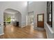 Spacious living room with hardwood floors, arched doorway, and ample natural light creating a warm atmosphere at 8517 Evans Mill Pl, Raleigh, NC 27613