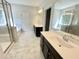 Bright bathroom featuring double vanity, soaking tub, and a separate glass-enclosed shower at 8813 Moss Glen Dr, Raleigh, NC 27617