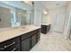 Spacious Primary bathroom with double sink vanity, dark wood cabinetry, tile floors, and walk-in shower at 8813 Moss Glen Dr, Raleigh, NC 27617