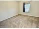 Small bedroom with neutral carpet and window with blinds, perfect for a home office at 8813 Moss Glen Dr, Raleigh, NC 27617