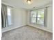 Bright bedroom with plush carpeting, featuring two large windows and neutral wall color, creating a cozy space at 8813 Moss Glen Dr, Raleigh, NC 27617