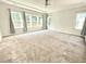 Large bedroom with a ceiling fan and windows providing natural light and a nice view at 8813 Moss Glen Dr, Raleigh, NC 27617